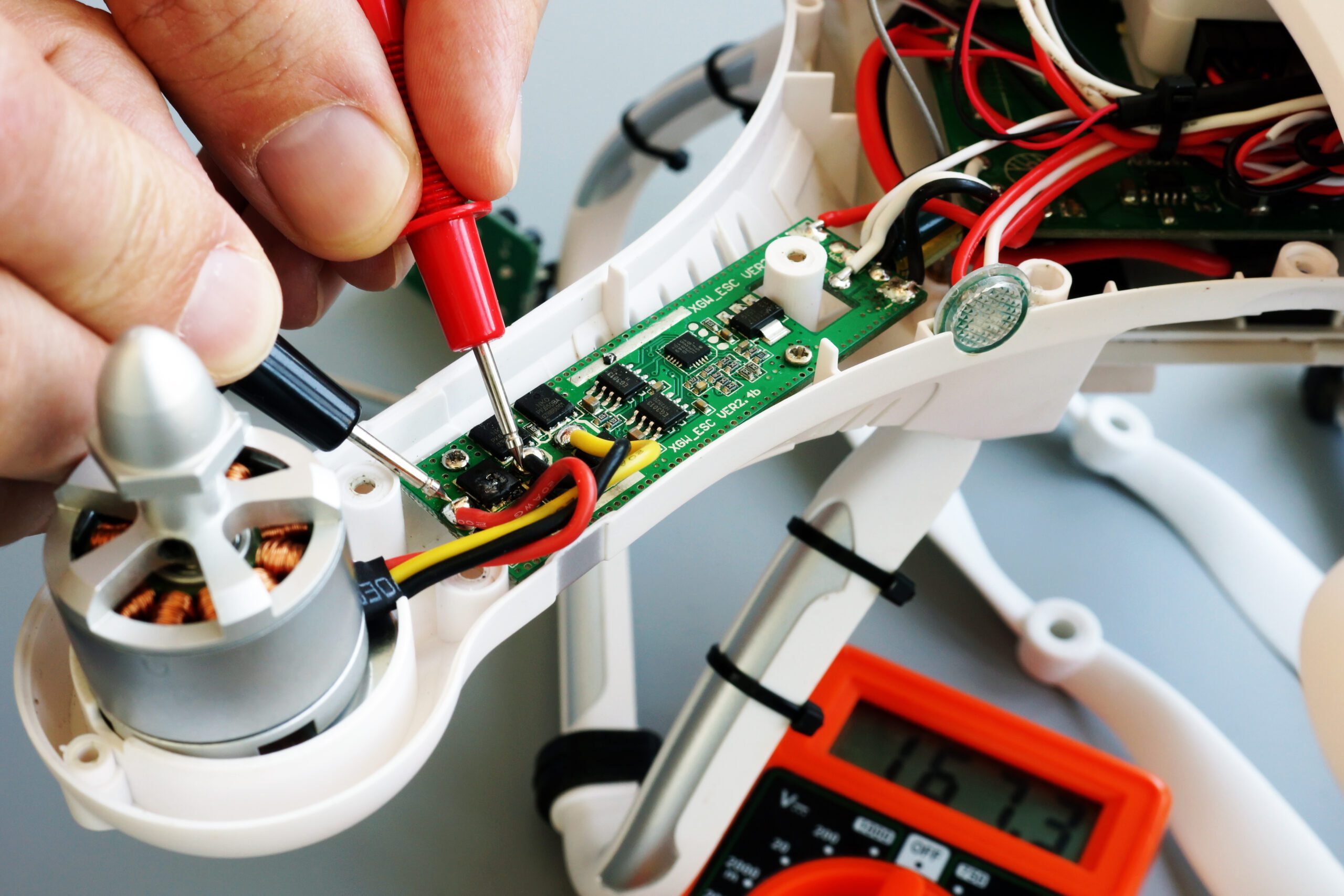 Man repairing drone Fixing problems with quadrocopter